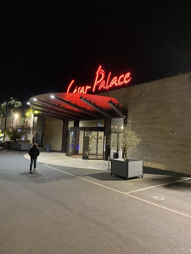 Illuminated entrance to Casino JOA César Palace de Saint-Paul-lès-Dax at night