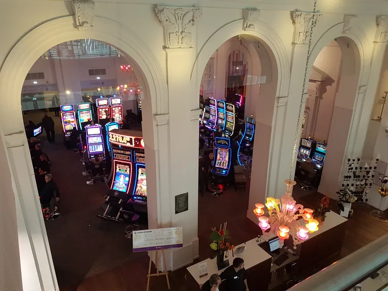 Elegant arched interior with gaming machines at Casino JOA d'Uriage