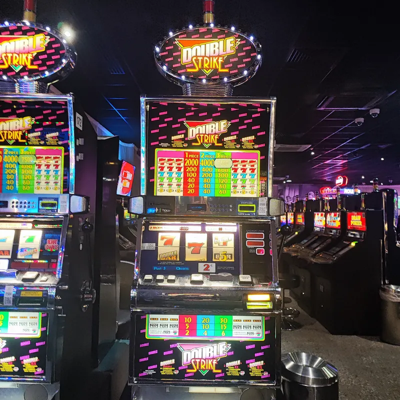 Brightly illuminated slot machines at Casino JOA d'Uriage