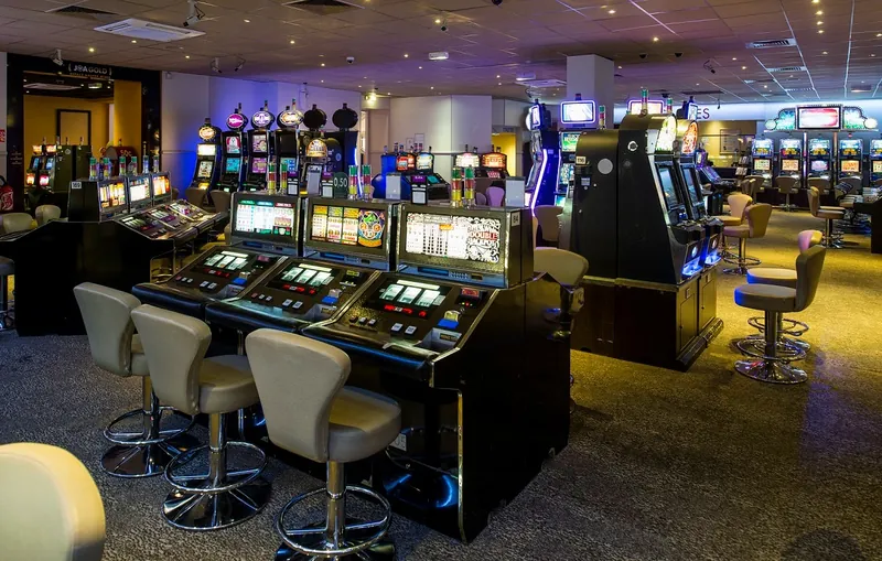 Wide gaming hall filled with slot machines at Casino JOA d'Uriage