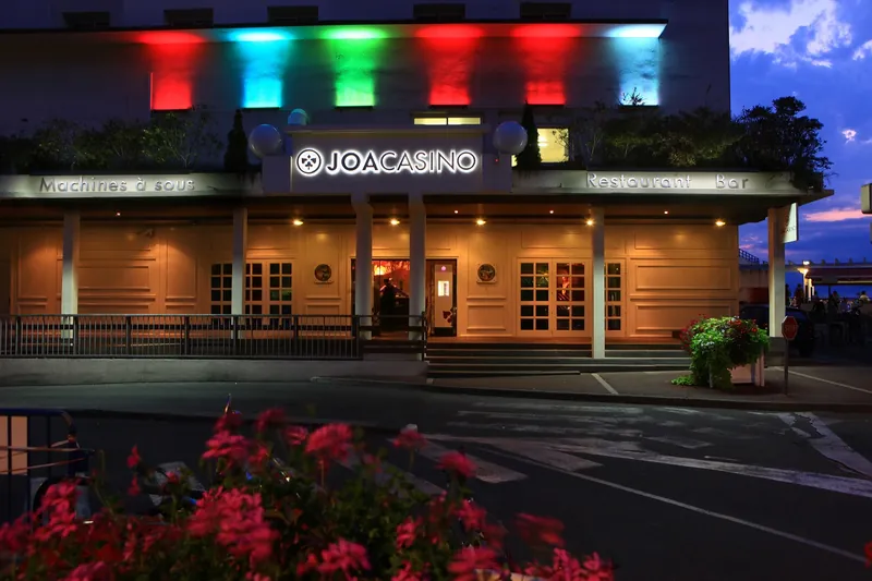 Red-lit exterior of Casino JOA de Saint-Jean-de-Luz at night